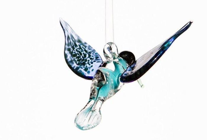 Aqua glass hummingbird pendant infused with cremains featuring a hanging hook for display.