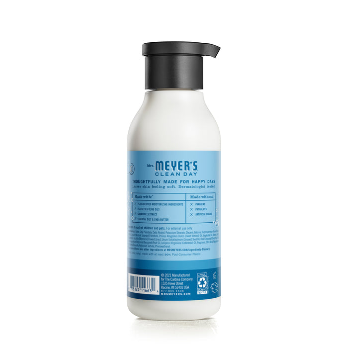 Mrs. Meyers Body Lotion features a black pump, blue label, and is infused with garden-inspired scents. The naturally derived formulas benefits and usage are detailed on the label, set against a white background.