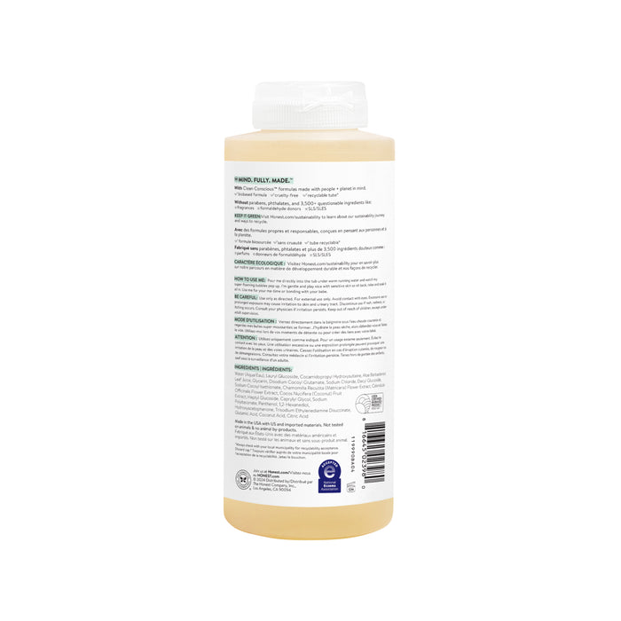 The Honest Companys Bubble Bath bottle features a beige label with small black and green text, a white cap, and product info on the reverse side. Ingredients include chamomile extract. Certified for quality, its perfect for creating a soothing bubble bath experience.