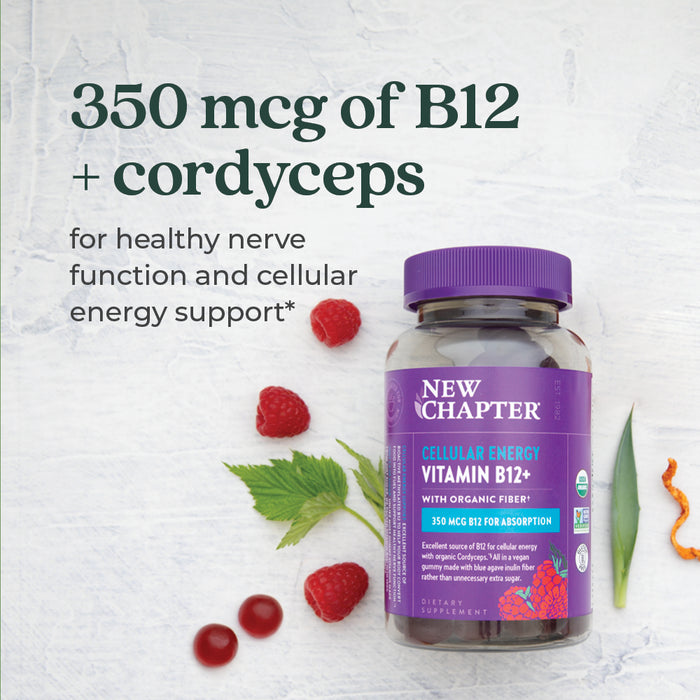 A bottle of New Chapter Cellular Energy Vitamin B12 + Gummies, Raspberry Flavored, rests on a white surface with raspberries, goji berries, a green leaf, and carrot slice. Text highlights 350 mcg B12 for nerve function and cellular energy support.