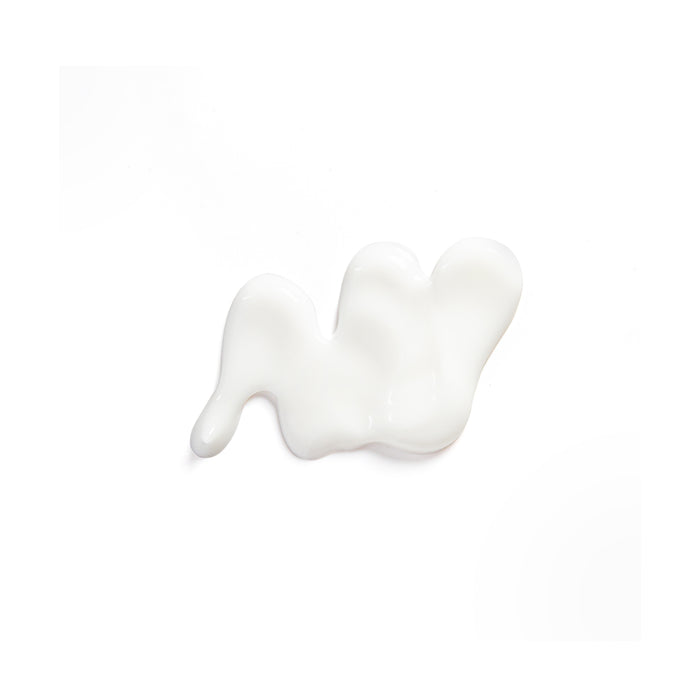 A small, irregular dollop of Tree To Tubs Cocoa & Shea Butter Anti-Aging Hand Cream for Dry Hands rests on a plain white background, exuding a calming presence.