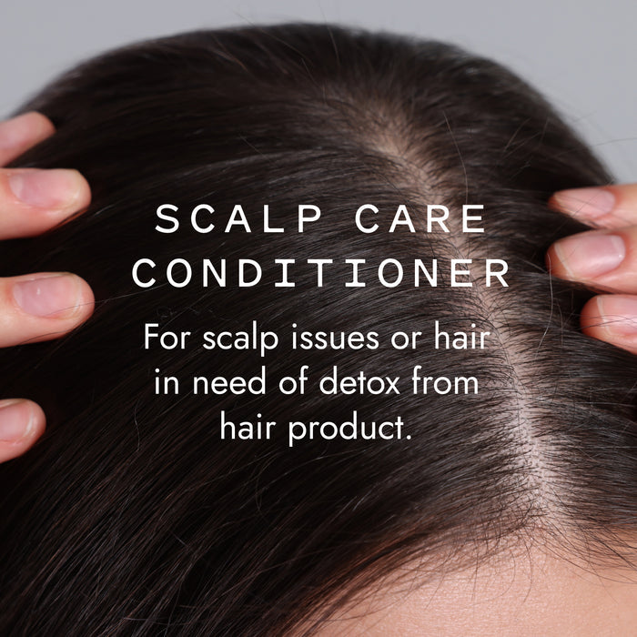 Close-up of a person parting dark hair to show their scalp, with text: Good Juju Body & Home Scalp Care Conditioner Bar—perfect for relieving dandruff and detoxing hair from product buildup with a natural formula.