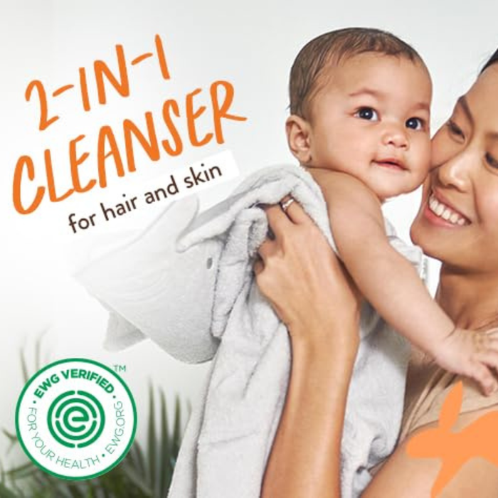A smiling woman holds a baby wrapped in a towel. Text reads “2-in-1 Cleanser for hair and skin.” A green EWG Verified seal appears in the bottom left corner. Babo Botanicals Sensitive Baby Baby Shampoo & Wash is a plant-based cleanser that doubles as a sensitive baby shampoo, perfect for your little one’s delicate skin and hair.