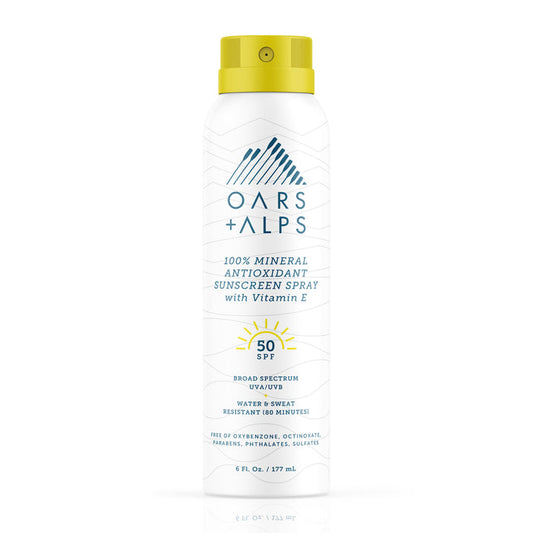 A can of Oars + Alps 100% Mineral Antioxidant Sunscreen Spray - SPF 50 comes in a white can with blue text and a yellow cap, offering broad spectrum protection and water resistance for 80 minutes.