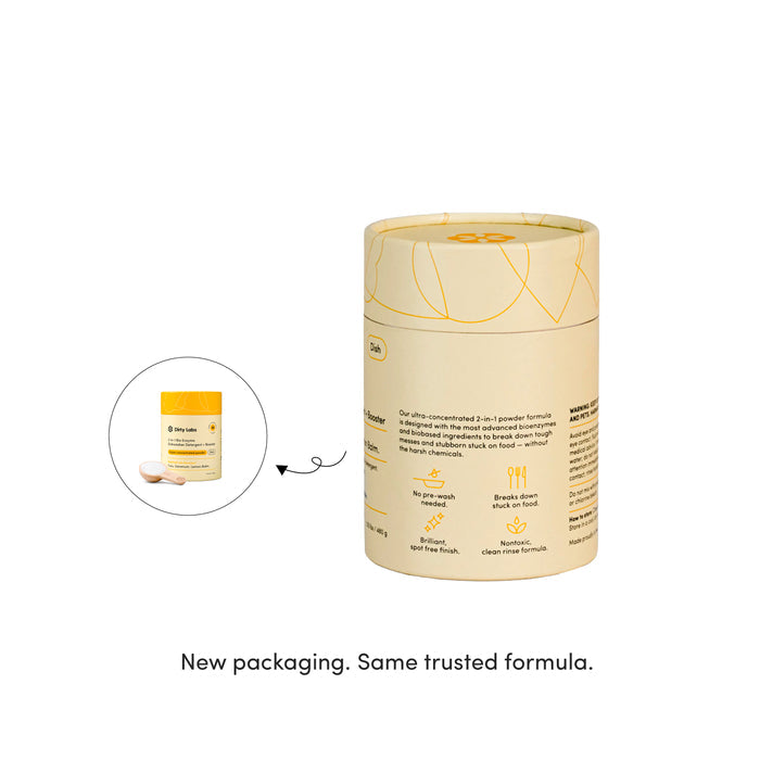 A cylindrical container of Dirty Labs 2-in-1 Bio Enzyme Dishwasher Detergent + Booster in yellow and beige packaging is shown next to its previous, smaller yellow container. Text below reads: New packaging. Same trusted 2-in-1 powder formula with bioenzymes.