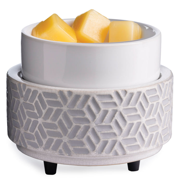 The 2-in-1 Classic Warmer by Candle Warmers Etc. is a white ceramic wax warmer with a light gray geometric pattern, featuring a separate top bowl holding yellow wax melt cubes. This stylish piece elegantly stands on four small black feet.