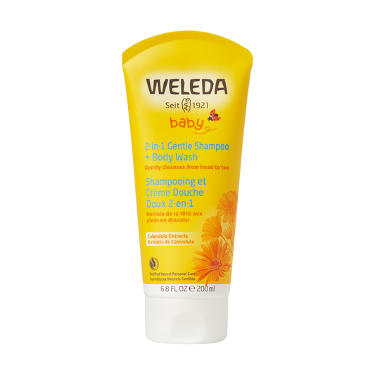 The 6.8 fl oz yellow tube of Weledas 2 in 1 Gentle Shampoo + Body Wash is enriched with calendula and sweet almond oil. The packaging features calendula flowers, highlighting its gentle cleansing properties.