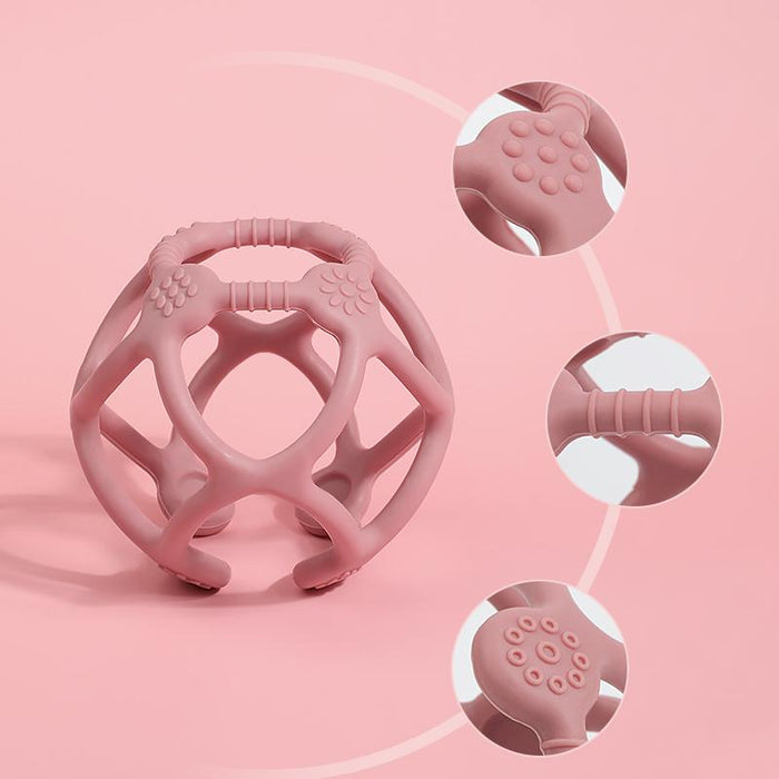 The Haakaa 100% Food Grade Silicone Teething Ball, in pink and BPA-free, features diverse grip textures like a ridged handle and circular bumps. FDA-approved, its ideal for soothing gums with its unique surface detail highlighted on a pink backdrop.