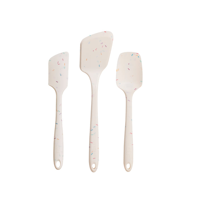 Three white silicone spatulas with confetti specks, made from heat-resistant, pharmaceutical-grade silicone, are shown vertically against a white background. Each differs in size and shape and is part of the GIR 3-Piece Ultimate Tool Set for your kitchen needs.