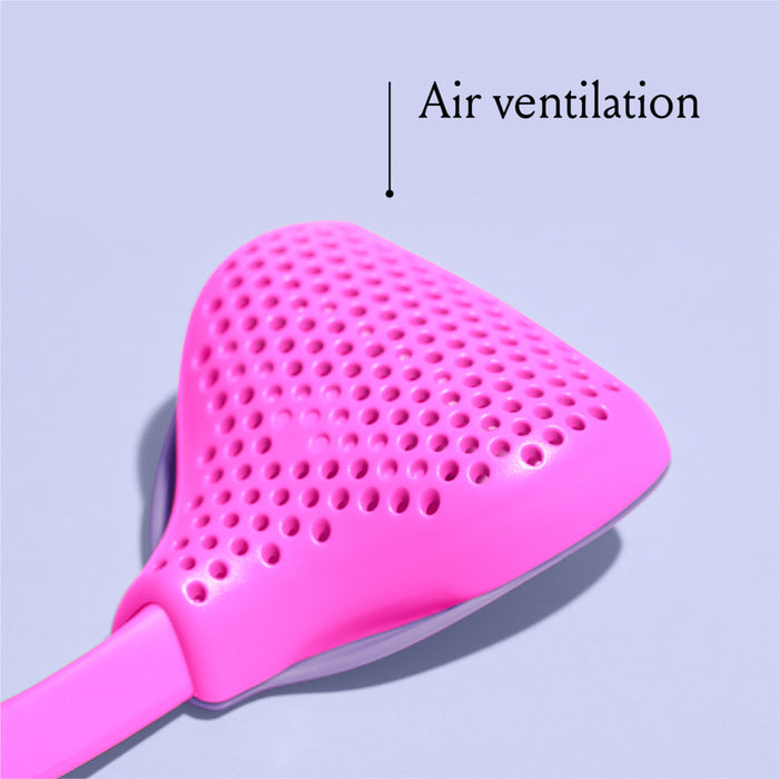 Close-up of a pink object with a perforated, triangular surface, labeled "Air ventilation." The background is a light lavender color.