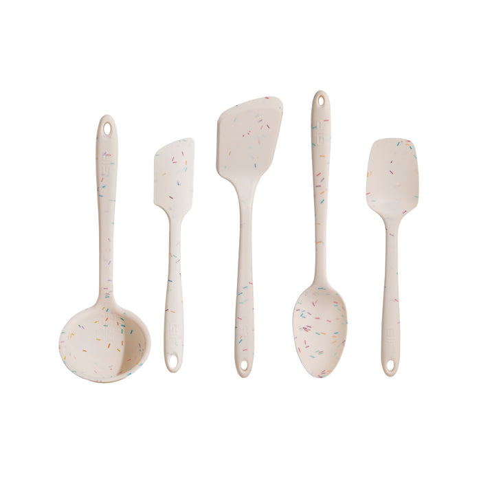 The 5-Piece Ultimate Tool Set by GIR includes a ladle, spatula, slotted spoon, and two scrapers. Made from pharmaceutical-grade silicone with multicolored sprinkles, each heat-resistant white utensil features a hanging hole and is arranged vertically.