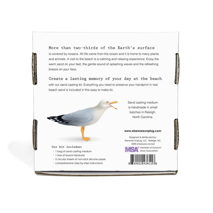 The back of the A Day at the Beach Set by Elseware Unplug features a seagull illustration, lists kit contents, includes a barcode and design/manufacturing credits, and highlights sand casting memories at the beach with this unique kit.