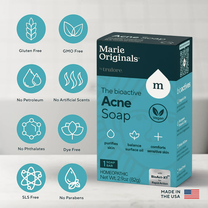 A Marie Originals Acne Control Soap box rests on a light surface, with icons highlighting natural salicylic acid, detoxifying clay, gluten free, vegan, and more. Made in the USA without harsh chemicals.