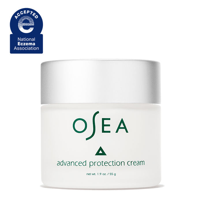 A white OSEA Advanced Protection Cream jar with a silver lid, labeled 1.9 oz (55 g), features a blue "Accepted, National Eczema Association" badge and is infused with Undaria seaweed for marine moisture.