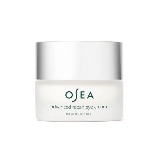 The OSEA Advanced Repair Eye Cream comes in a white jar with a metallic lid, containing 0.6 oz / 18 g of an anti-aging formula designed to reduce puffiness and rejuvenate the eyes.
