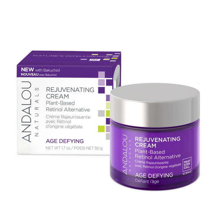 A purple cosmetic jar labeled Age Defying Rejuvenating Plant Based Retinol Alternative Cream by Andalou Naturals, features a boxed packaging with leaf and text designs. This age-defying cream is enriched with bakuchiol and fruit stem cell science. Product weight: 50g.