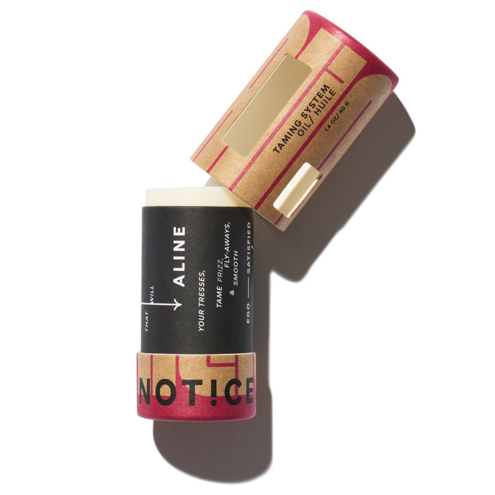Two cylindrical containers with red and black designs are shown. One is open, revealing a white stick labeled Aluminum-Free Deodorant, vegan. The closed one reads ALINE Solid Hair Oil by NOT!CE Hair Co to tame frizz.