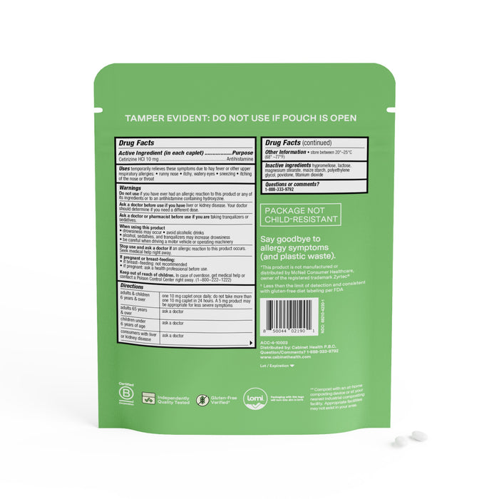 A green package from Cabinet Health displays drug facts, warnings, and allergy relief benefits. It features recycling symbols, a barcode, and Tamper Evident, but isnt child-resistant. Nearby are two white pills with cetirizine HCl similar to Zyrtec for allergy relief.