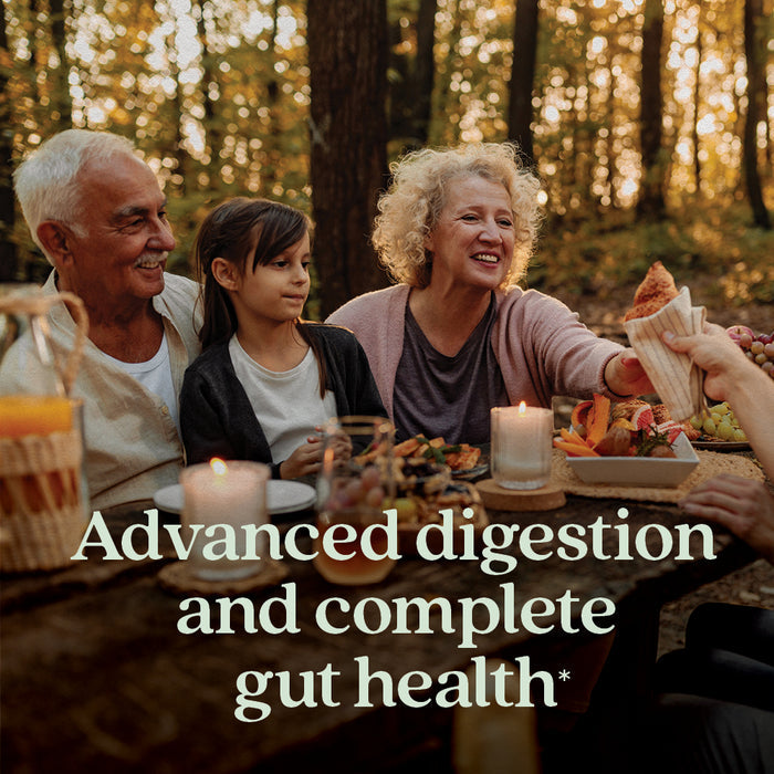 Three adults and a young girl share a meal at a rustic outdoor table in the woods, with candles and a basket. Text: New Chapter All-Flora™ Probiotic for Advanced Digestion & Complete Gut Health.