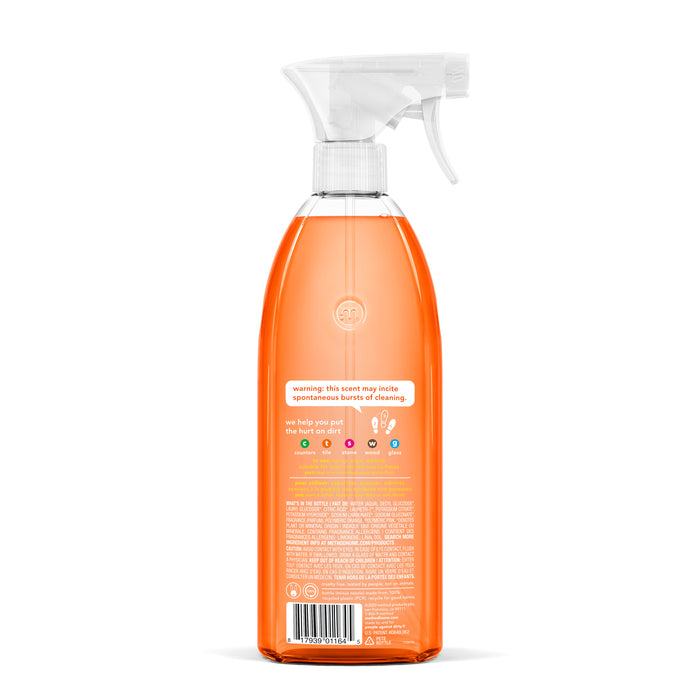 A transparent spray bottle with orange liquid and a white nozzle highlights the natural cleaning power of methods All Purpose Cleaner, while the label, featuring text and symbols, offers product details and warnings.