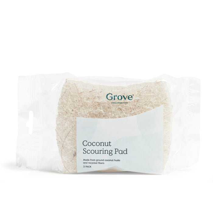 A clear plastic package holds two Grove Co. Coconut Scouring Pads, crafted from ground coconut husks and recycled fibers for eco-friendly and effective cleaning.