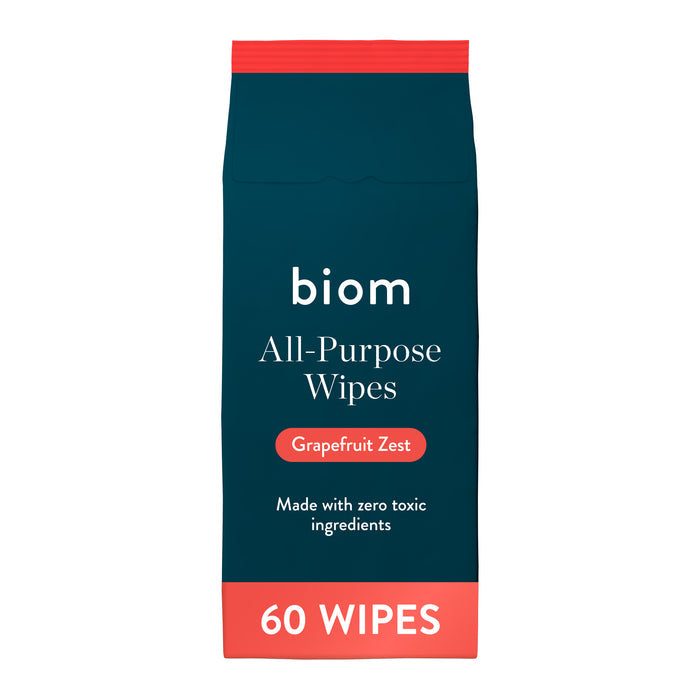 A package of Biom All-Purpose Wipe Refills in Grapefruit Zest scent, featuring 60 plant-based wipes made without toxic ingredients. These natural wipes come in dark blue and red packaging, providing an eco-friendly solution for everyday cleaning tasks.