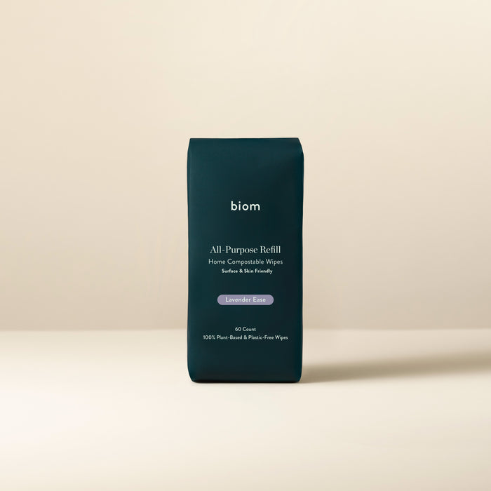 Biom All-Purpose Wipe Refills rest on a neutral backdrop. The dark green pack features Lavender Ease in white and lavender text and contains 60 plant-based cleaning wipes that are completely plastic-free.