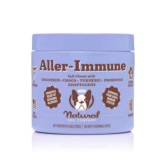 Natural Dog Companys Aller-Immune Supplement soft chews provide natural allergy relief and immune support for dogs with colostrum, chaga, turmeric, probiotics, and adaptogens. The purple jar with a dog illustration offers 90 bites and highlights seasonal allergy benefits.