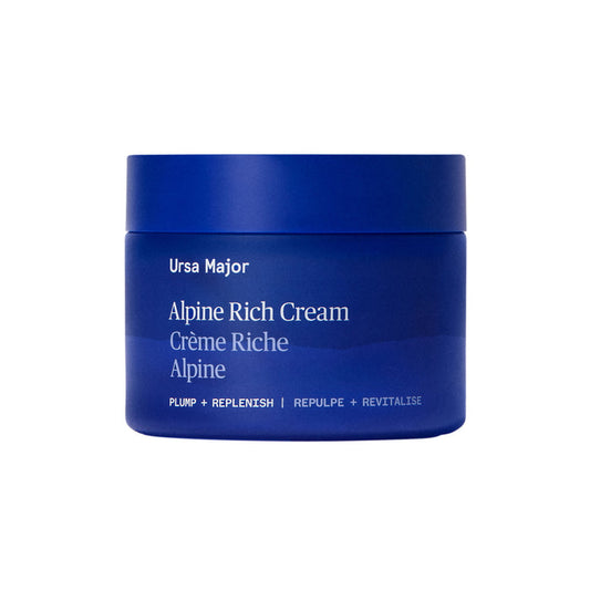 A blue jar of Ursa Major Alpine Rich Cream, labeled with "Plump + Replenish | Repulpe + Revitalise" in white text, hydrating and supporting the skin barrier. The minimalist jar appears on a white background.