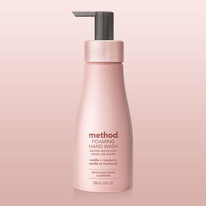 A pink Aluminum Foaming Hand Soap by method with a pump dispenser, featuring vanilla + raspberry scents and with plant-based cleansers. This 300 ml (10 fl oz) sensitive skin-friendly soap sits against a gradient pink background, adding a luxurious touch.