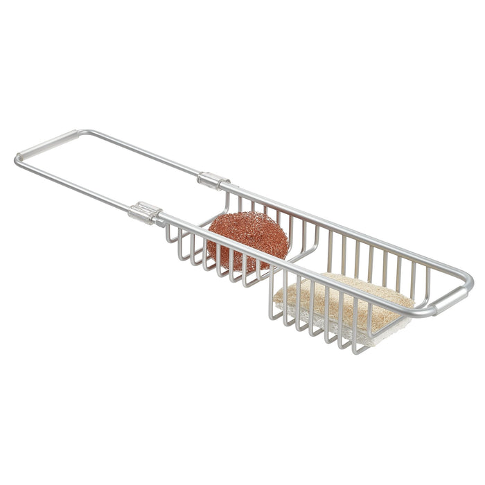The iDesign Aluminum Over The Sink Basket is rust-resistant and features a sliding handle, holding two cleaning pads (brown and beige). Its perfect for drying or organizing dishwashing items in the kitchen.