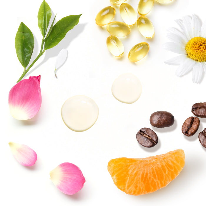 Flat lay image showcasing a pink rosebud, green leaves, chamomile flower, fish oil capsules, coffee beans, an orange slice, and cosmetic cream drops next to Tree To Tubs Anti-Aging Peptide & Niacinamide Serum For Face on a white background.