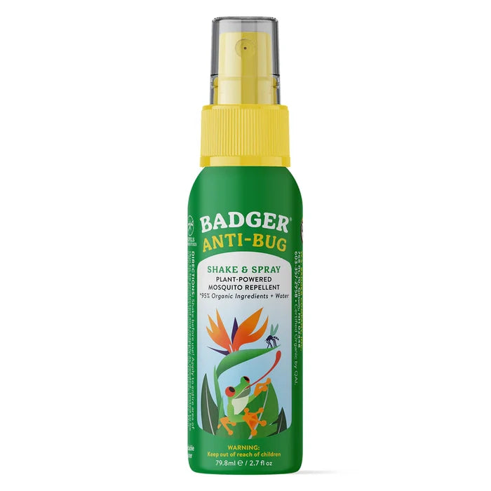 A green and yellow Badger Balm Anti-Bug Shake & Spray bottle features plant images, a mosquito, and people outdoors. This organic, DEET-free insect repellent uses plant-powered ingredients like citronella and lemongrass.