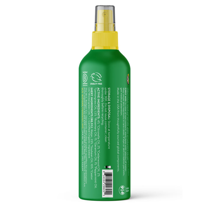 A green spray bottle of Badger Balm Anti-Bug Shake & Spray - Mosquito Repellent with a yellow cap is shown from the back, displaying white text listing ingredients and product details. The DEET-free bug spray’s label also features certification and recycling symbols near the bottom.