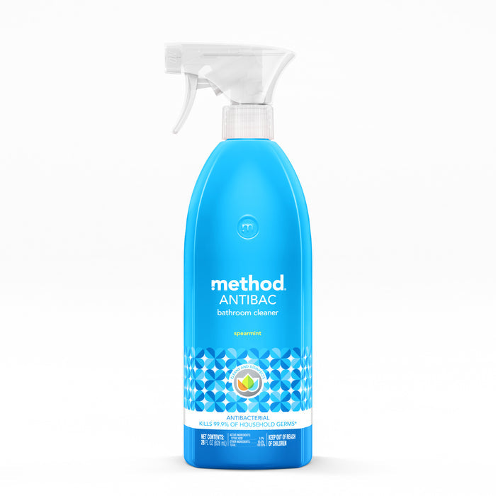 The Method Antibacterial Bathroom Cleaner in spearmint scent is a strong disinfectant with a label featuring white text and geometric patterns, claiming to kill 99.9% of household germs. The blue bottles white trigger spray top makes it easy to use.