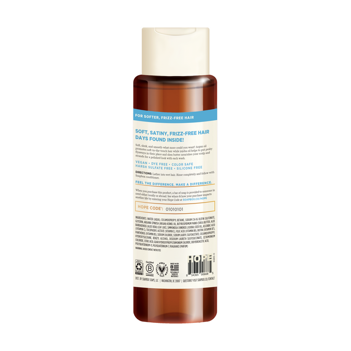 The Argan Oil Softening Shampoo by Soapbox has a tan flip-top cap and a label with icons and text, promoting Soft, Satiny, Frizz-Free Hair. It highlights being Vegan, Sulphate-Free, and is enriched with argan oil.