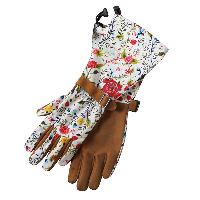 The Arm Saver Gloves by Womanswork are long gardening gloves with floral-patterned fabric on top, brown leather palms, adjustable straps, and a logo. Proudly crafted by a woman-owned business.