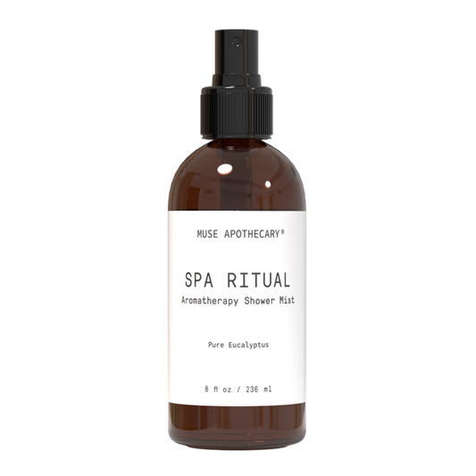 The Aromatherapy Shower Mist by Muse Apothecary, in a brown bottle, offers a luxurious self-care experience with aromatic Eucalyptus oil. It contains 8 fl oz / 236 ml of pure bliss and features a sleek black spray nozzle for easy use.