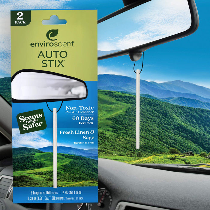 The image showcases Enviroscent Auto Air Freshener Stix, an eco-friendly, non-toxic car scent in Fresh Linen & Sage. It includes two liquid-free diffusers and loops, with packaging set against a car interior overlooking a lush green landscape.