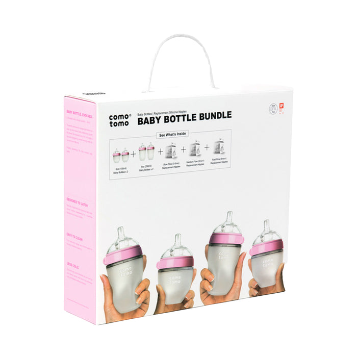 The Comotomo Baby Bottle Gift Set features four anti-colic bottles with pink lids in a row. The mostly white box, accented in pink and topped with a handle, is ideal for breastfeeding moms on the go.