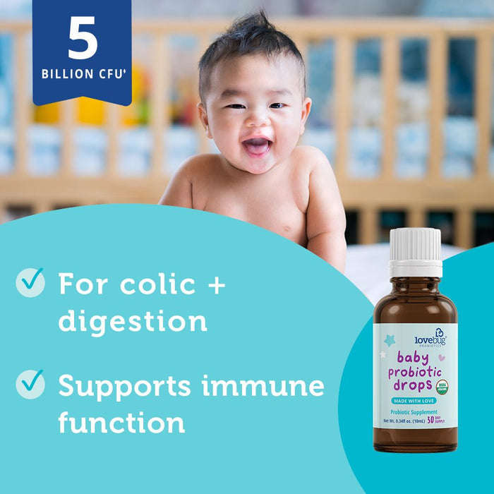 A smiling baby in a crib with Lovebugs Baby Probiotic Drops - Organic prominently displayed. The text highlights benefits: For colic + digestion, Supports immune system function, and mentions 5 billion CFU. Ideal for promoting digestive health and overall well-being.