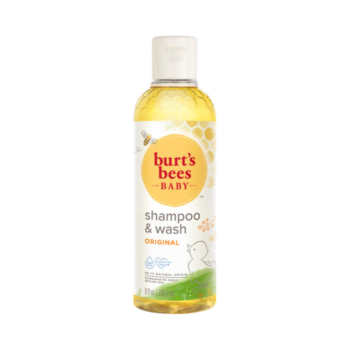 A soothing yellow liquid in an 8 fl oz (235 ml) bottle of Burts Bees Baby™ Shampoo and Wash features a label with honeycomb patterns and a cute duck, highlighting its tear-free, 99.9% natural origin formula made from natural ingredients.