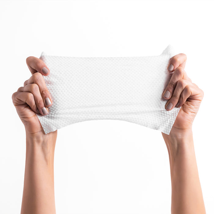 Two hands stretch a textured white cloth against a plain background, showcasing the flexibility and strength of DYPER Baby Wipes for Sensitive Skin.