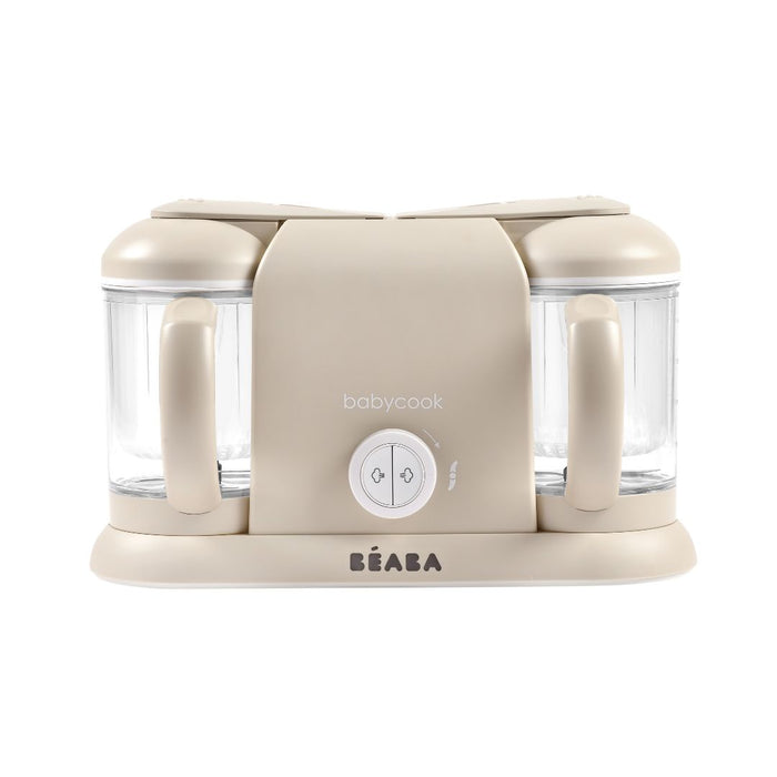 The BEABA Babycook Duo baby food maker in beige has dual transparent containers, handles for one-handed use, and a front-facing round control knob with babycook above. The brand name BEABA is elegantly displayed at the base—ideal for effortlessly making homemade baby food.