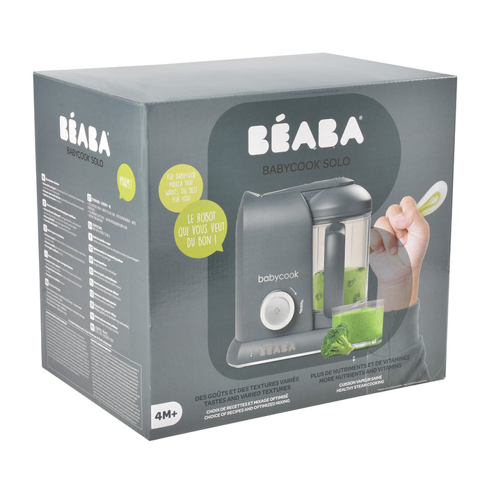 The BEABA Babycook Solo Baby Food Makers gray box showcases its ability to steam, blend, and defrost homemade baby food. Designed for infants 4 months and up, the packaging includes French text highlighting its features for effortless meal preparation.