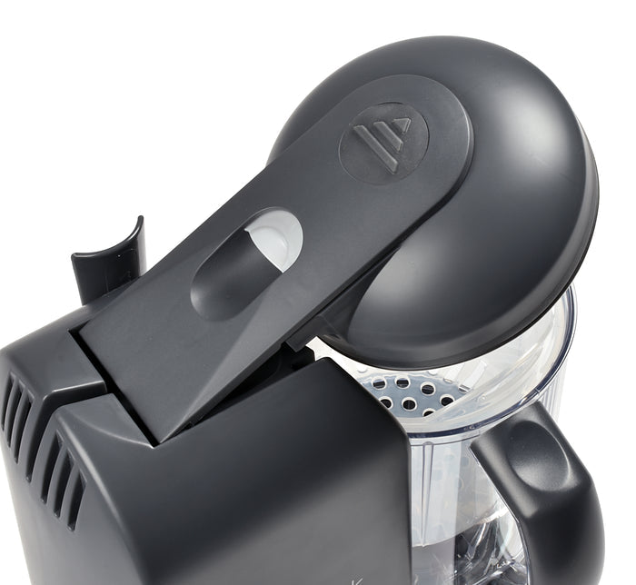 Close-up of the BEABA Babycook Solo Baby Food Maker, showcasing its open lid and citrus reamer. This modern design features a transparent container and small spout, perfect for blending homemade baby food.