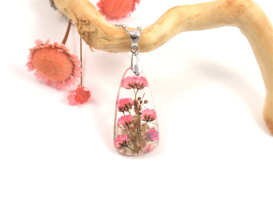 Teardrop resin pendant containing pink baby's breath flowers