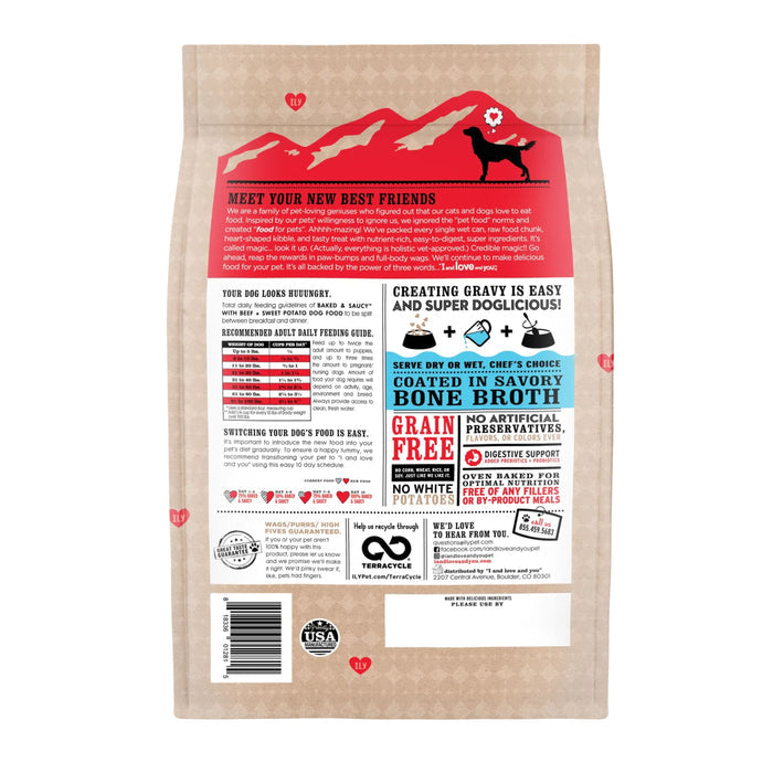 The back of the Baked & Saucy Dog Food - Beef Recipe bag by I and Love and You features red and black text on a tan background. Highlights include grain-free benefits, feeding instructions, mountain and heart graphics, USA farm-raised beef, a recycling icon, and a USA-made label.