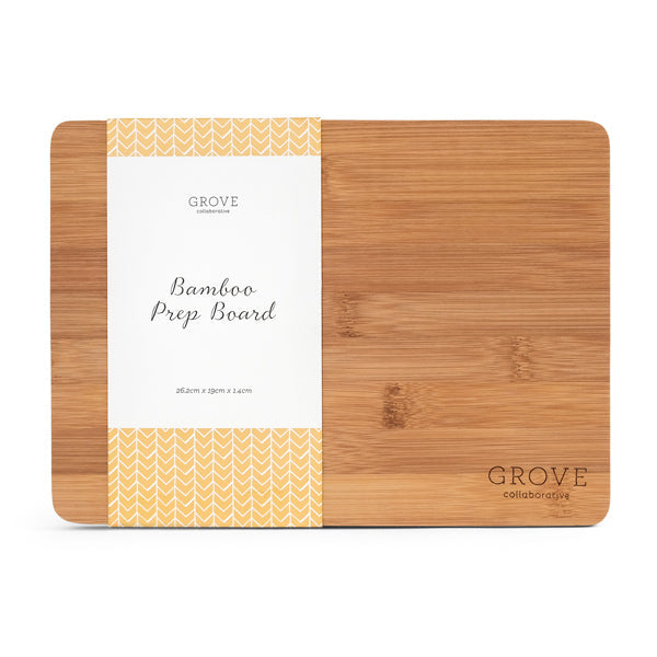 The Grove Co. Bamboo Prep Board, crafted from sustainable bamboo, has a left-side label saying Grove Collaborative Bamboo Prep Board, while the right side remains plain with GROVE engraved at the bottom, highlighting its naturally antibacterial properties.
