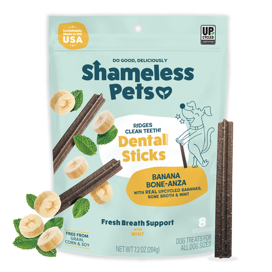 A bag of Shameless Pets Banana Bone-anza Dental Sticks, made in the USA with bananas and mint for fresh breath. This grain-free treat features two dental sticks on the package.